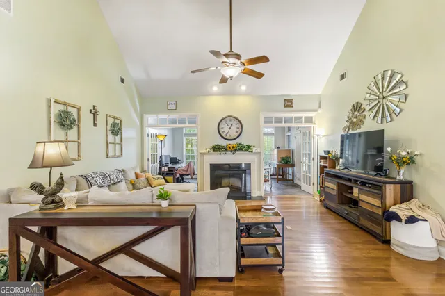 a living room with furniture a fireplace and a chandelier