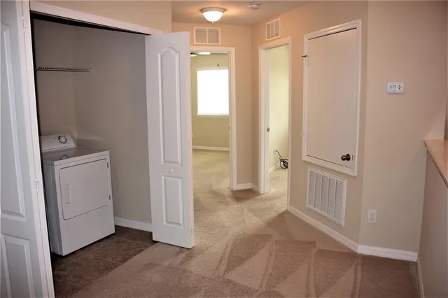 a view of a hallway with closet and entryway