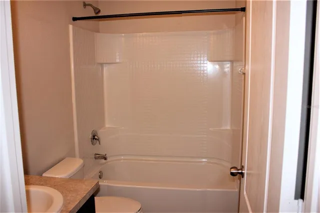 a bathroom with a shower and a toilet