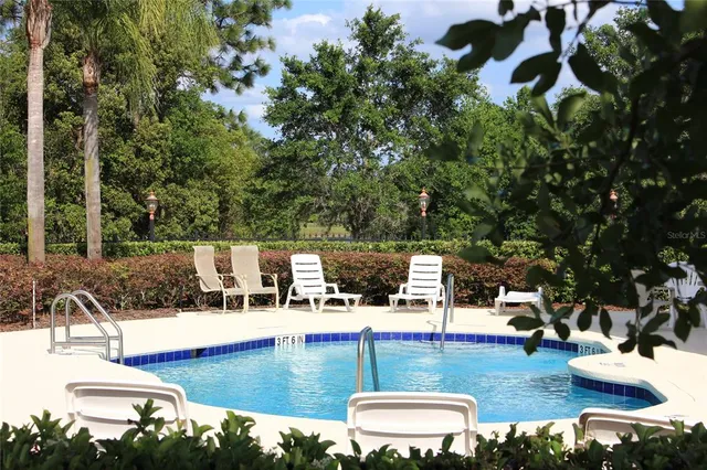 a view of a swimming pool with lounge chairs