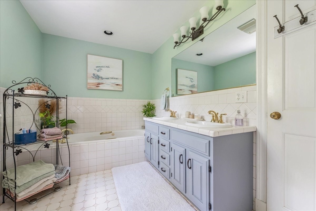 43 Simmons Road Hanover, MA 02339 - Photo 12 of 39 a bathroom with a tub a sink and a mirror