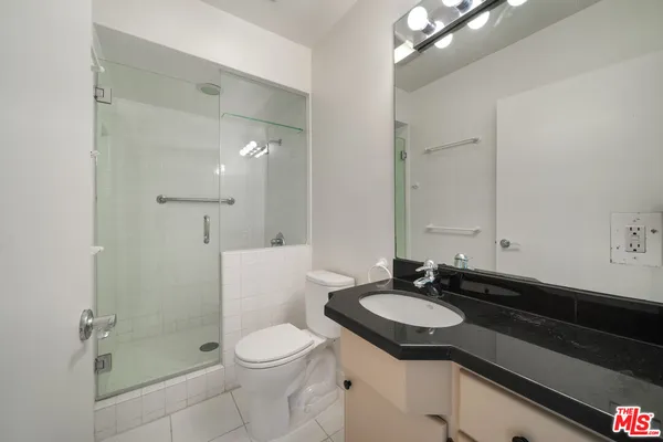 an empty room with closet and a ceiling fan