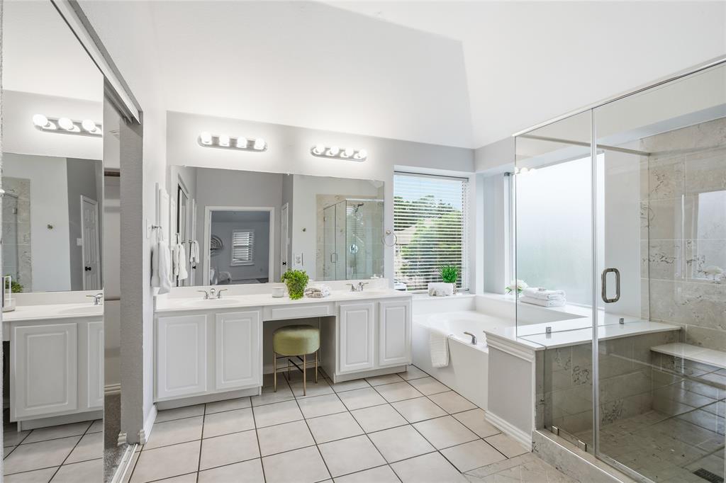 5201 Geode Lane McKinney, TX 75072 - Photo 20 of 37 Primary bathroom has a nice size garden tub surrounded by windows for natural light. Great for relaxing after a long day.