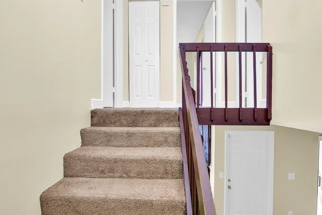 a view of staircase with white walls