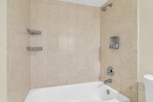 a bathroom with a white bath tub and a shower