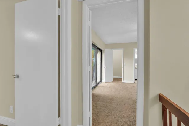 a view of a livingroom and a hallway