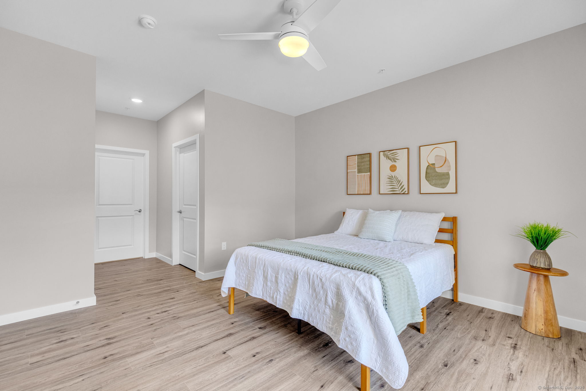 104 Episcopal Road, Unit 1 Berlin, CT 06037 - Photo 13 of 27 a bedroom with a bed and with a wooden floor