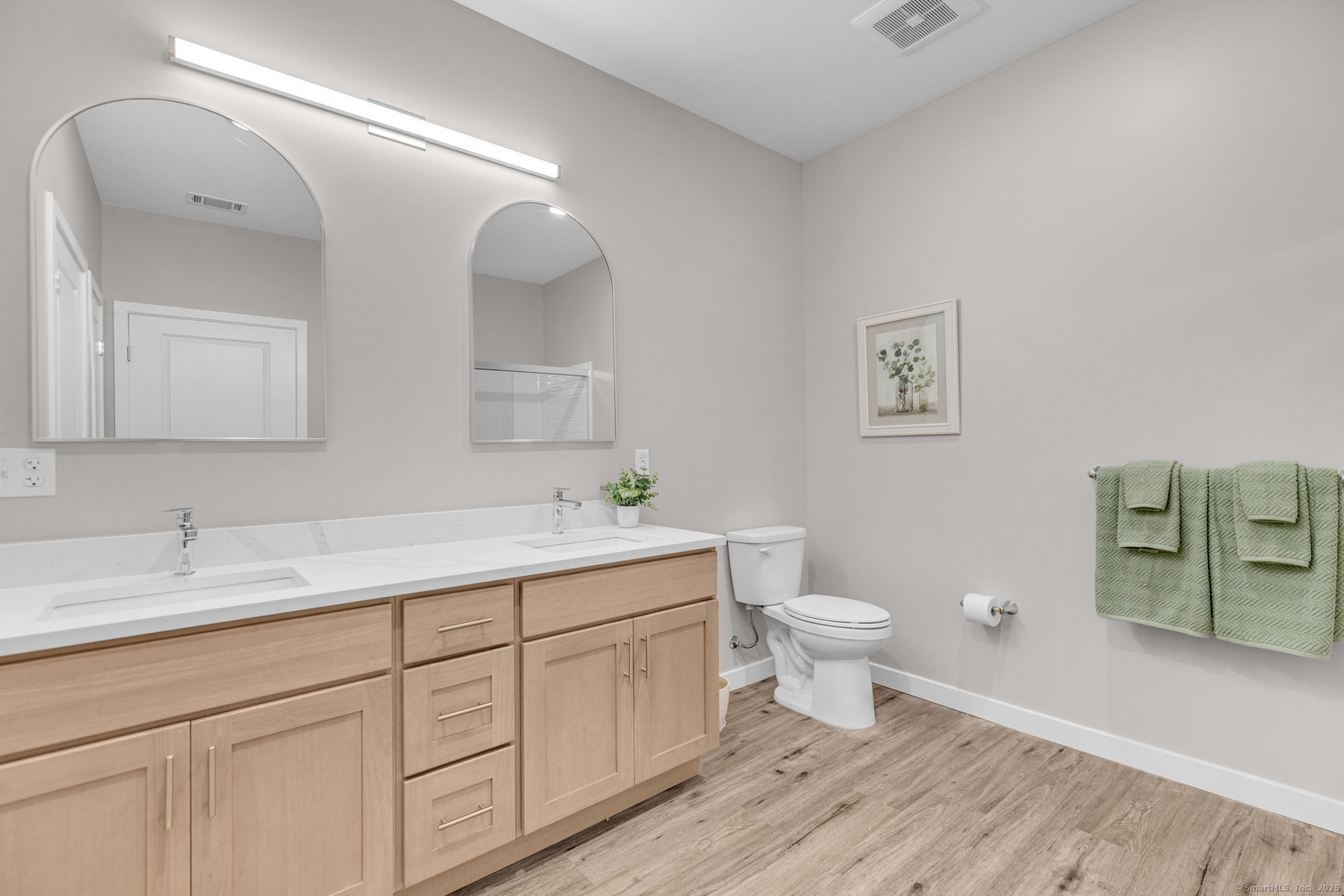 104 Episcopal Road, Unit 1 Berlin, CT 06037 - Photo 15 of 27 a bathroom with a toilet sink and mirror