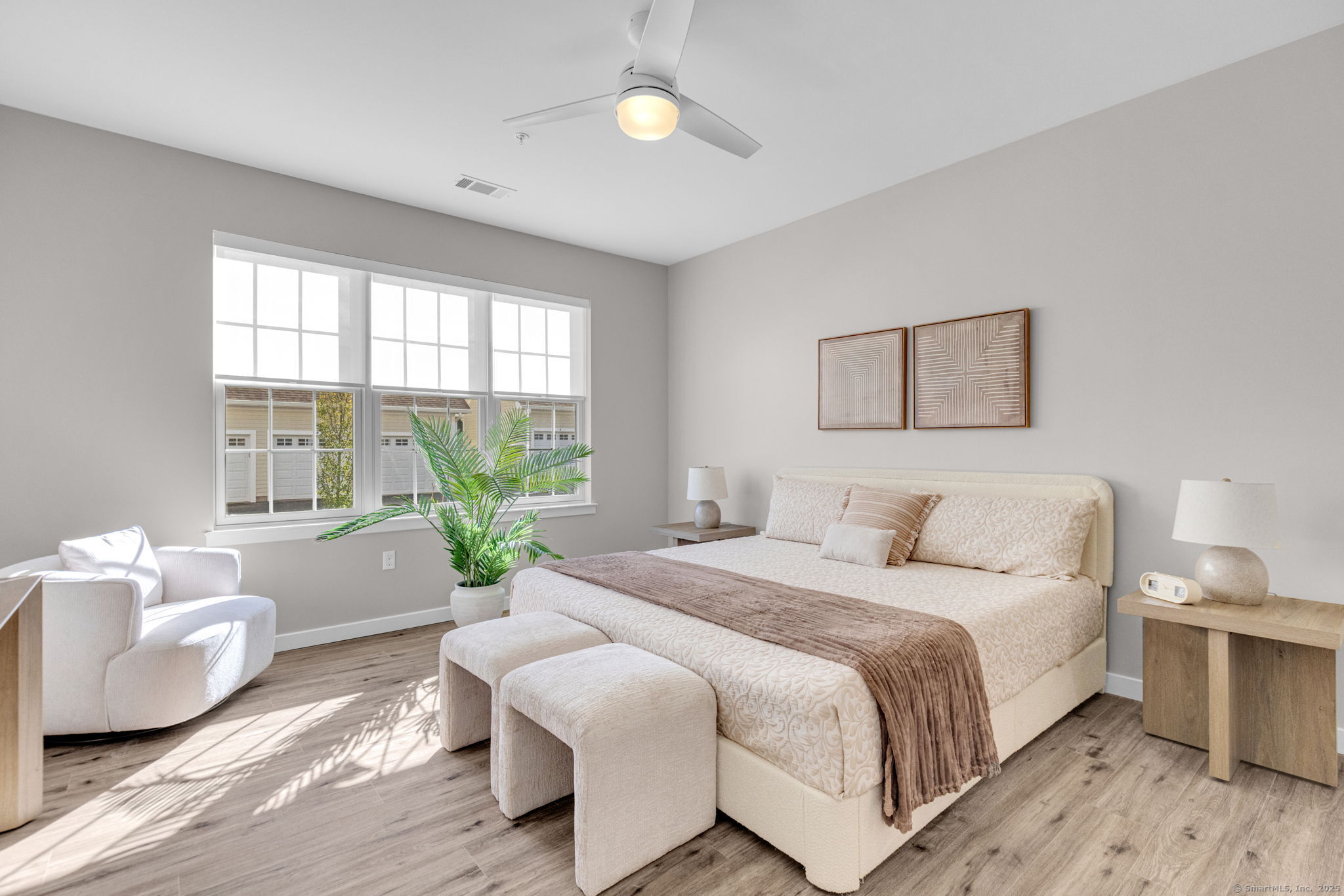 104 Episcopal Road, Unit 1 Berlin, CT 06037 - Photo 19 of 27 a spacious bedroom with a bed and wooden floor