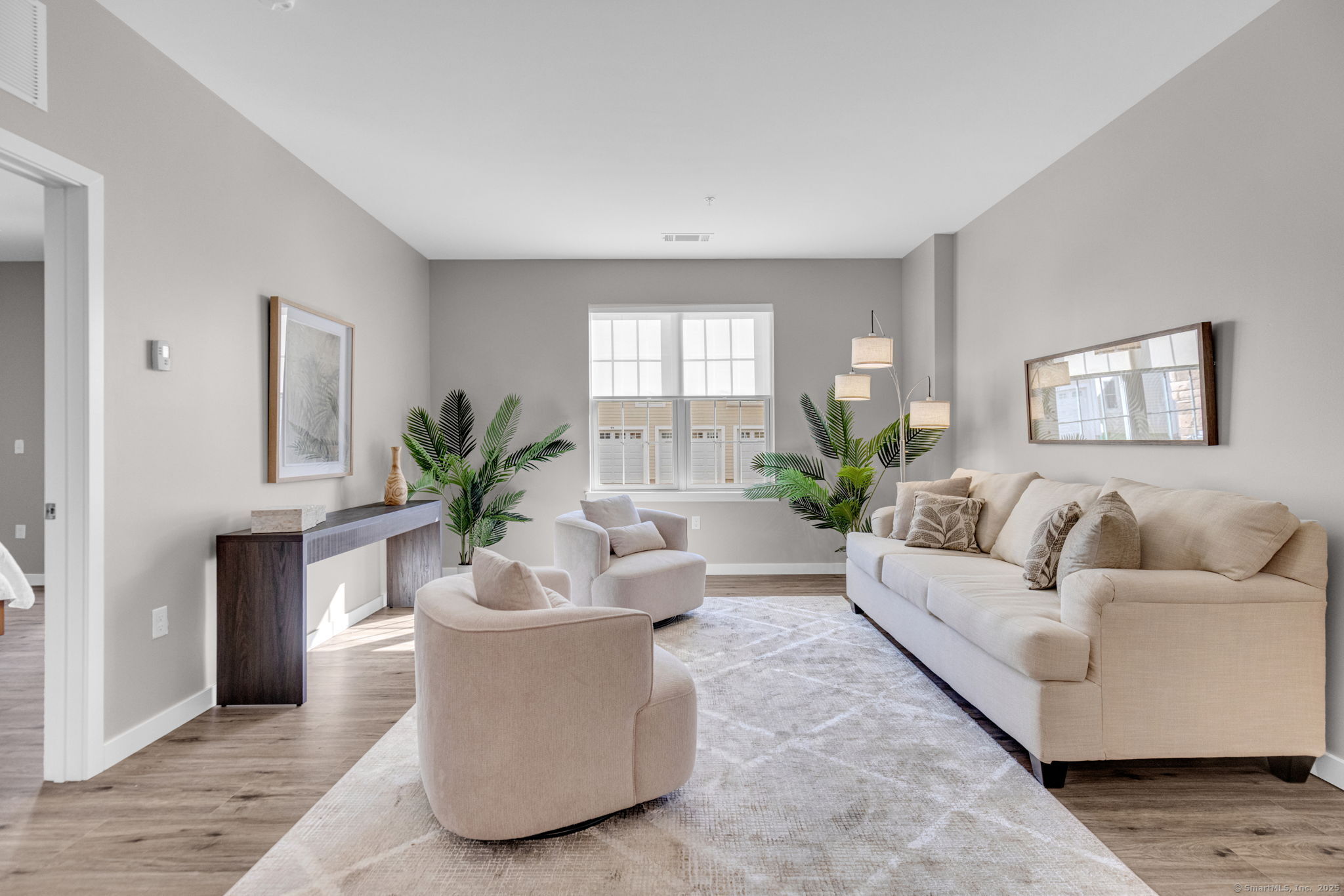 104 Episcopal Road, Unit 1 Berlin, CT 06037 - Photo 21 of 27 a living room with furniture potted plant and a window