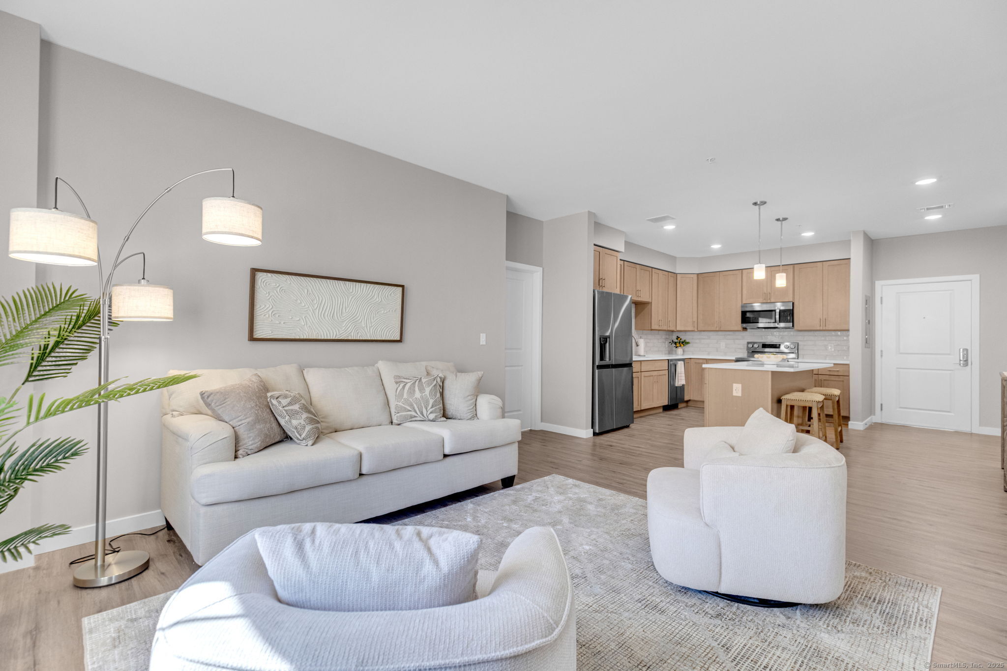 104 Episcopal Road, Unit 1 Berlin, CT 06037 - Photo 6 of 27 a living room with furniture and a dining table with kitchen view