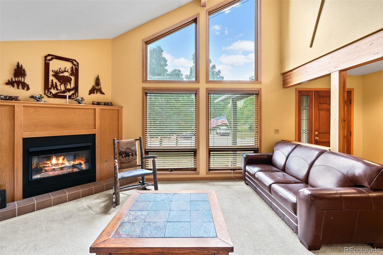 868 Deer Path Road Dillon, CO 80435 - Photo 11 of 50 a living room with furniture a large window and a fireplace