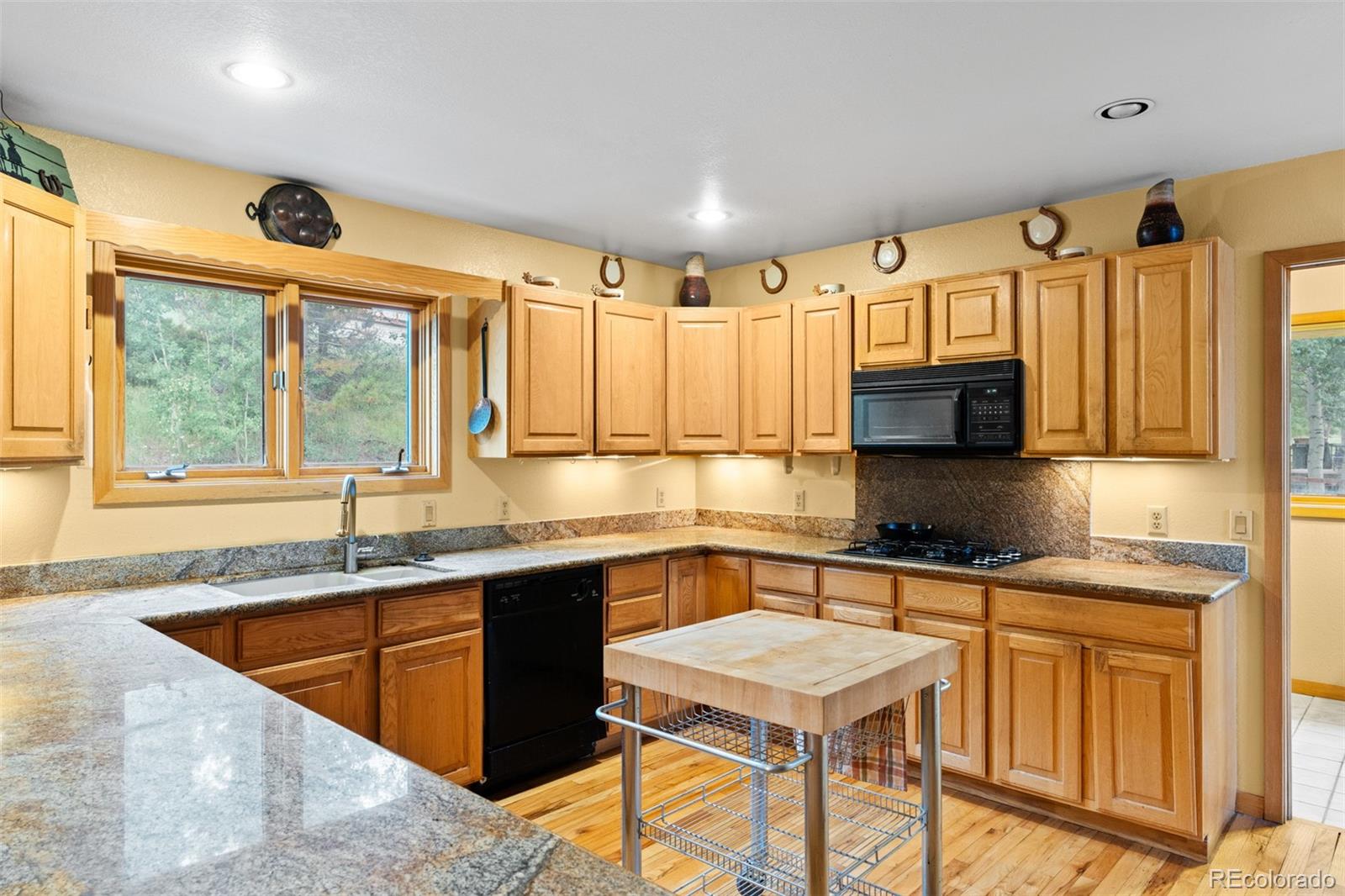 868 Deer Path Road Dillon, CO 80435 - Photo 18 of 50 a kitchen with stainless steel appliances granite countertop a sink stove and cabinets