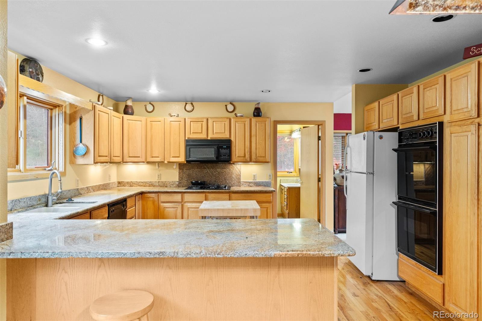 868 Deer Path Road Dillon, CO 80435 - Photo 19 of 50 a kitchen with stainless steel appliances granite countertop a sink refrigerator and microwave