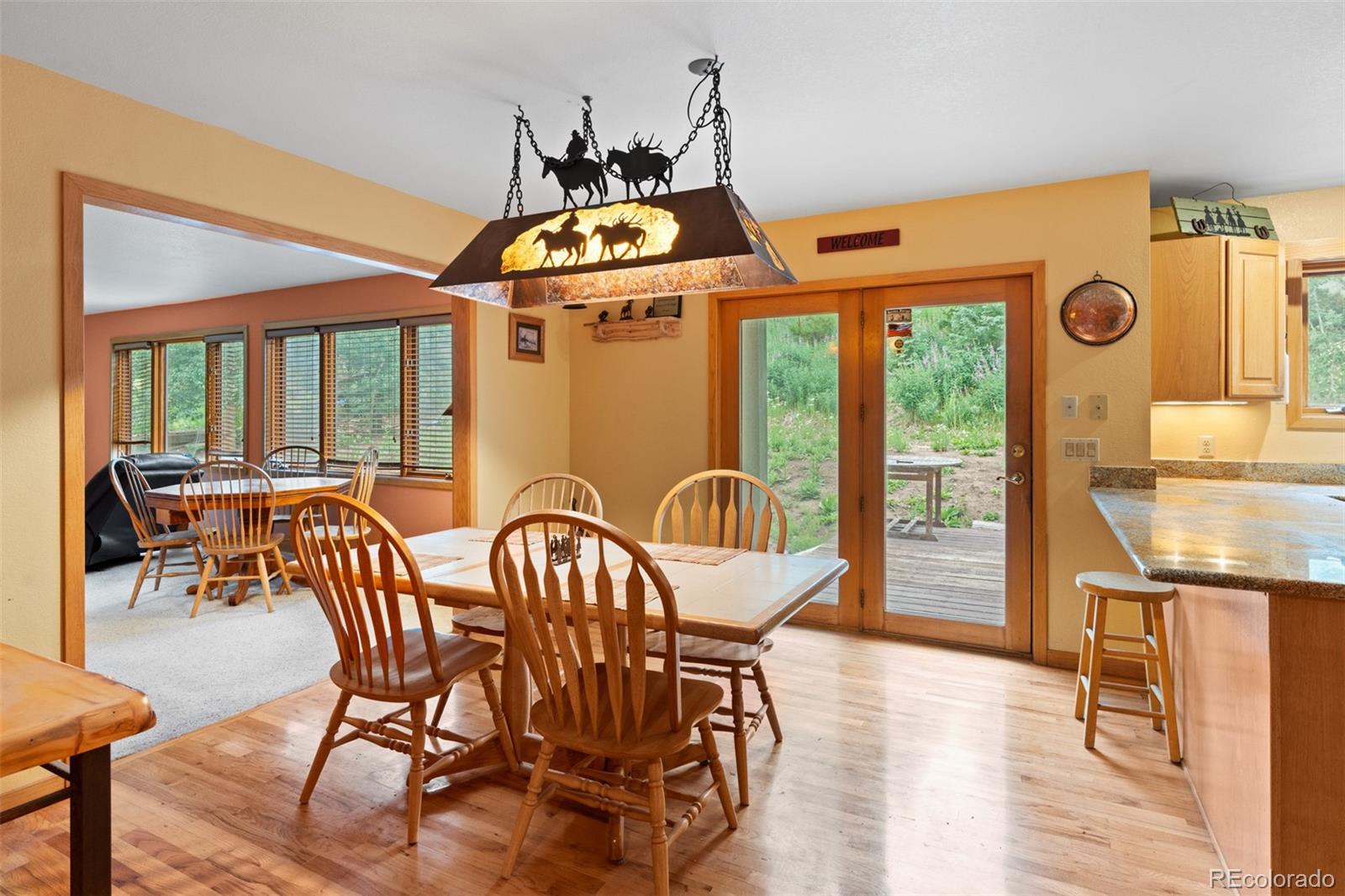 868 Deer Path Road Dillon, CO 80435 - Photo 24 of 50 a dining room with furniture a chandelier and wooden floor