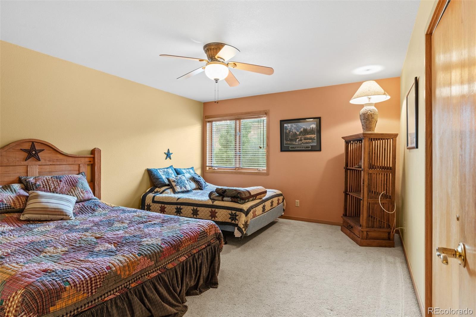 868 Deer Path Road Dillon, CO 80435 - Photo 40 of 50 a bedroom with two beds and a chandelier