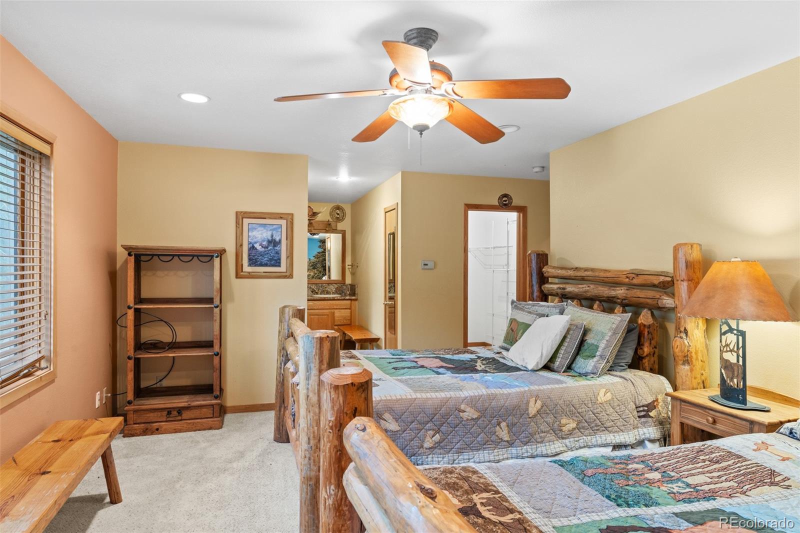 868 Deer Path Road Dillon, CO 80435 - Photo 45 of 50 a bedroom with a bed and a chandelier