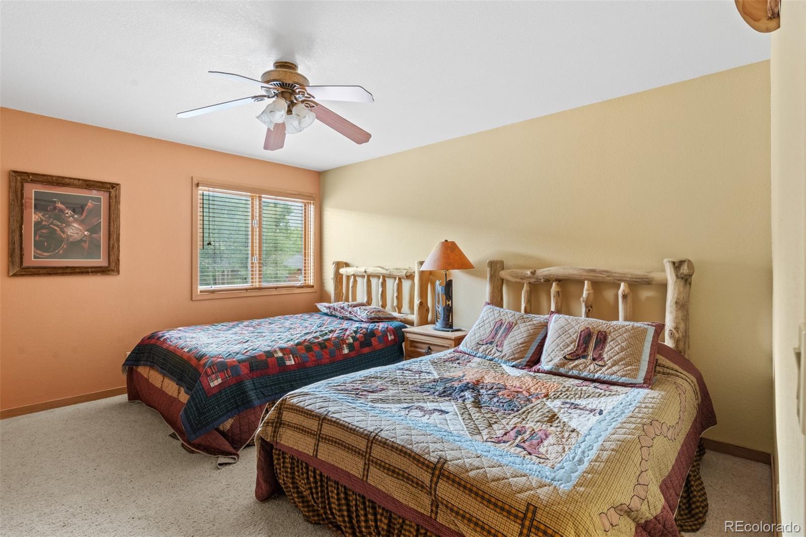 868 Deer Path Road Dillon, CO 80435 - Photo 48 of 50 a bedroom with two beds and a chandelier