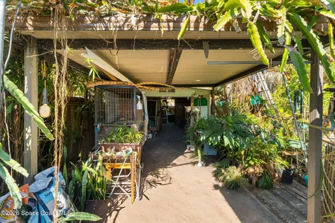 a view of a patio with table and chairs potted plants with wooden floor