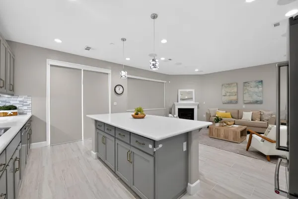 a kitchen with refrigerator and chairs