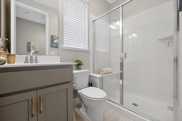 a bathroom with a sink double vanity and a mirror