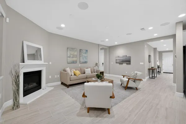 a living room with furniture a fireplace and a view