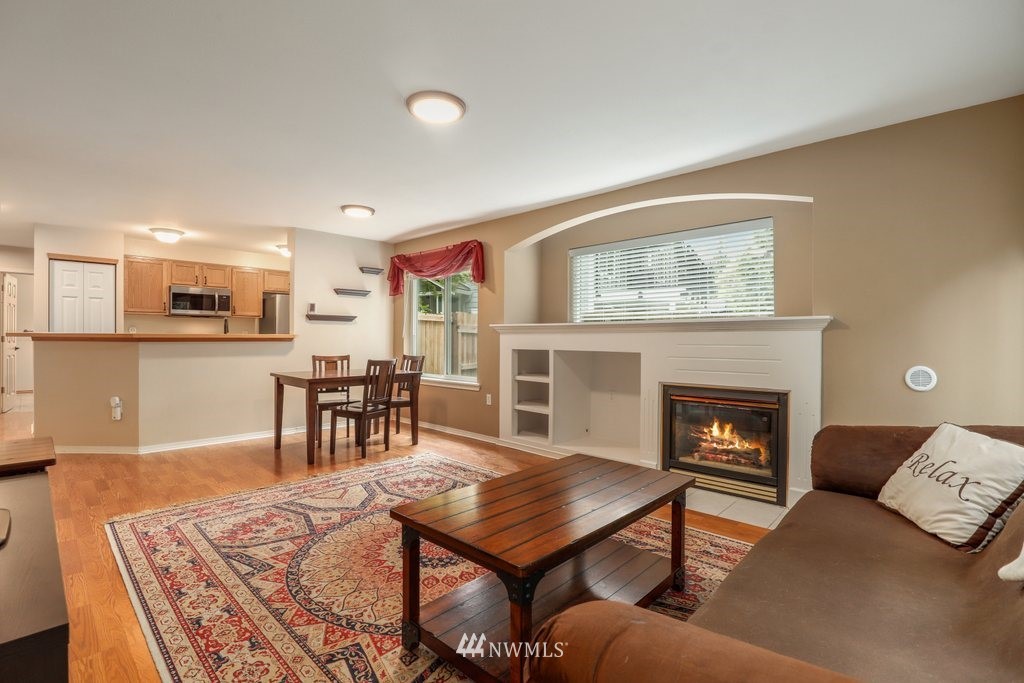 2201 192nd Street Southeast, Unit S101 Bothell, WA 98012 - Photo 6 of 33 a living room with furniture and a fireplace
