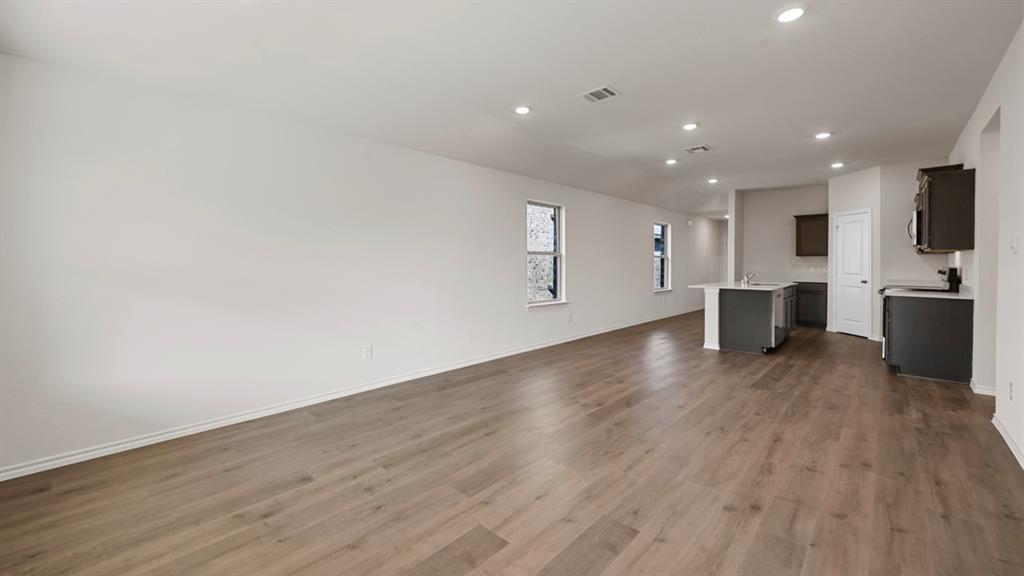 1663 Blaire Drive Tyler, TX 75704 - Photo 12 of 26 Open-concept living area featuring wood-finish flooring, recessed lighting, and multiple windows