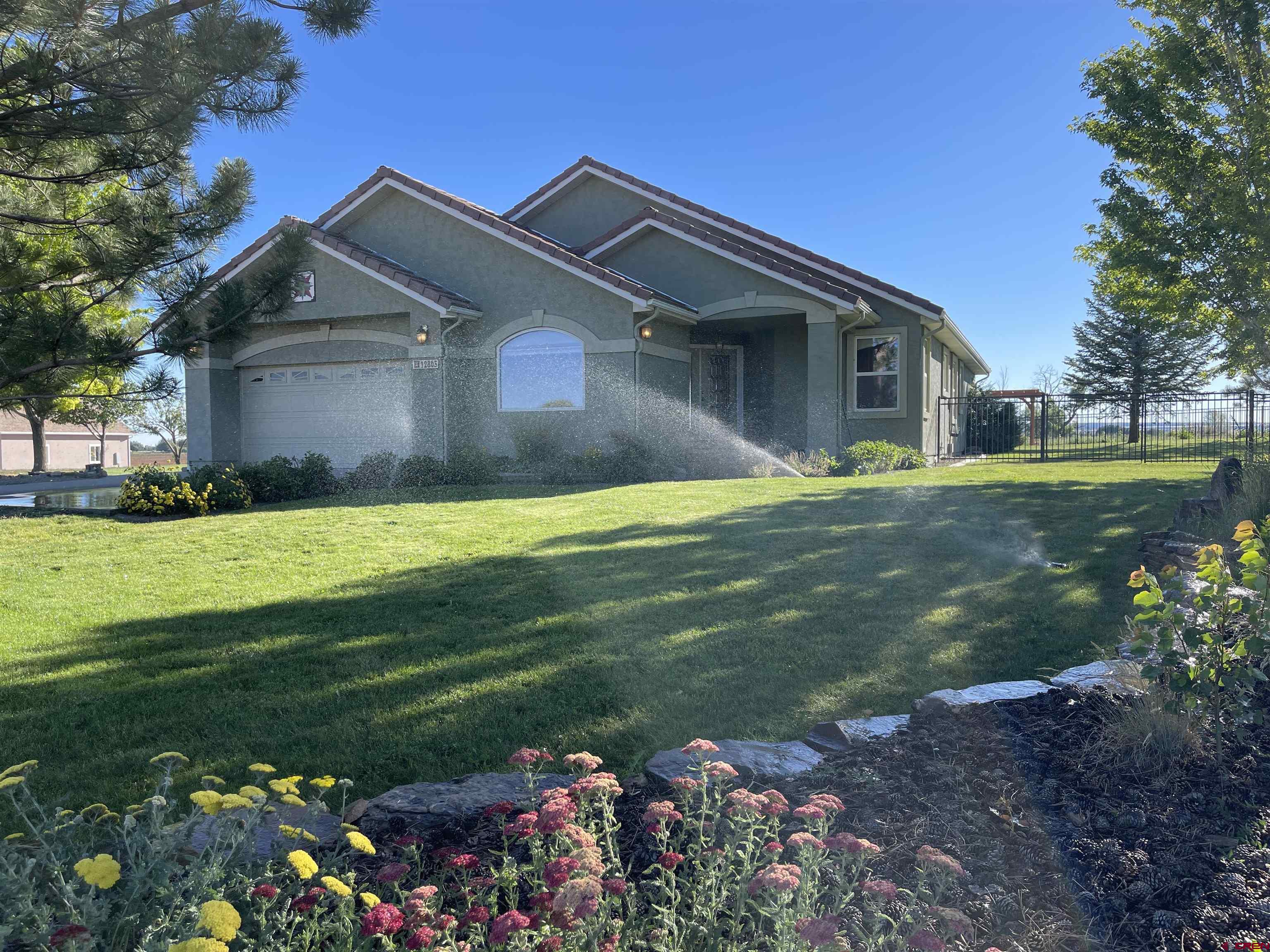 12863 24.4 Road Cortez, CO 81321 - Photo 1 of 35 a front view of a house with garden