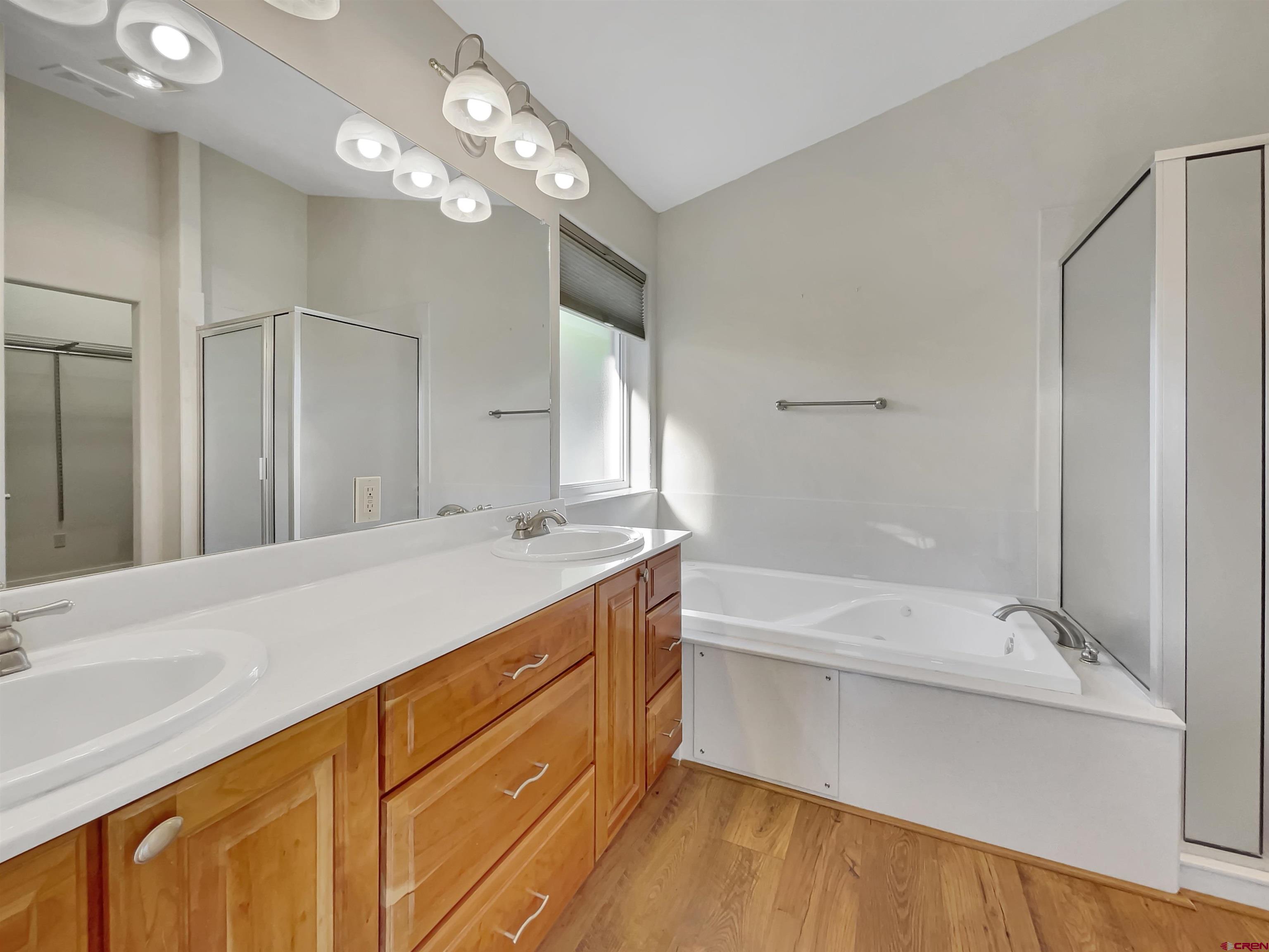 12863 24.4 Road Cortez, CO 81321 - Photo 17 of 35 a spacious bathroom with a bathtub shower sink and mirror