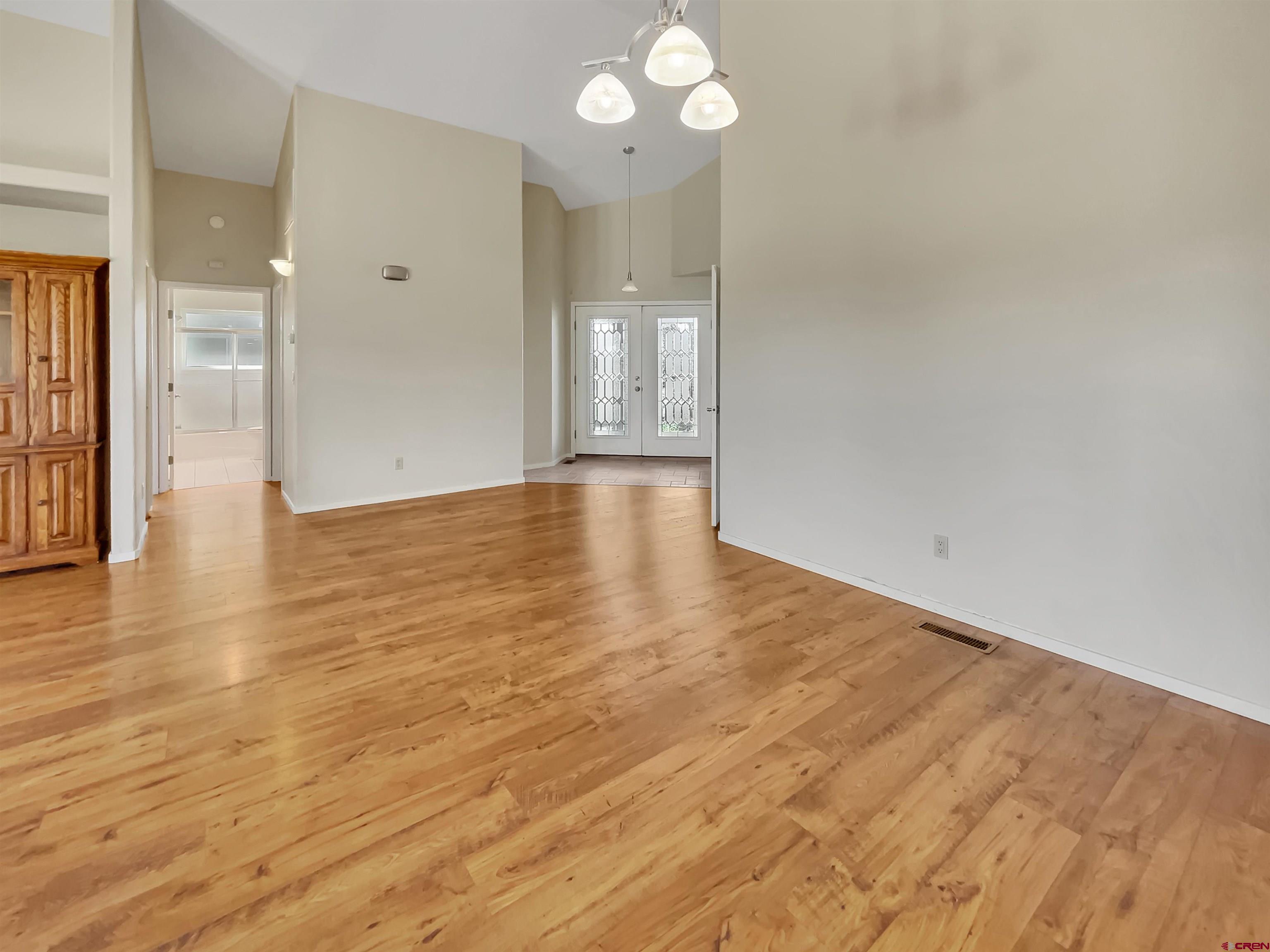 12863 24.4 Road Cortez, CO 81321 - Photo 7 of 35 a view of an empty room with wooden floor and a window