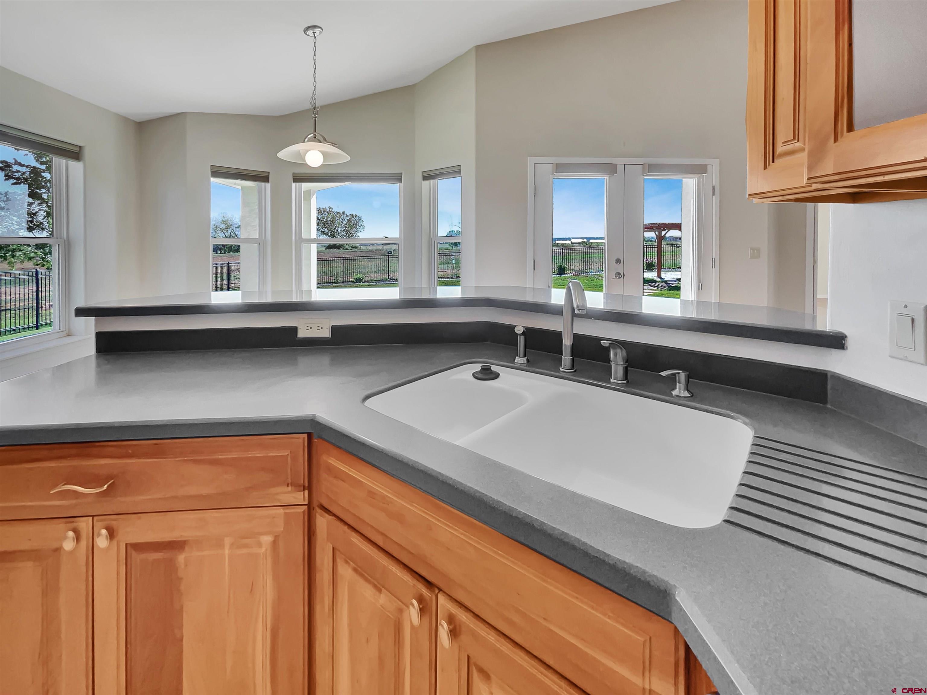12863 24.4 Road Cortez, CO 81321 - Photo 10 of 35 a view of a kitchen counter space with wooden floor and cabinets