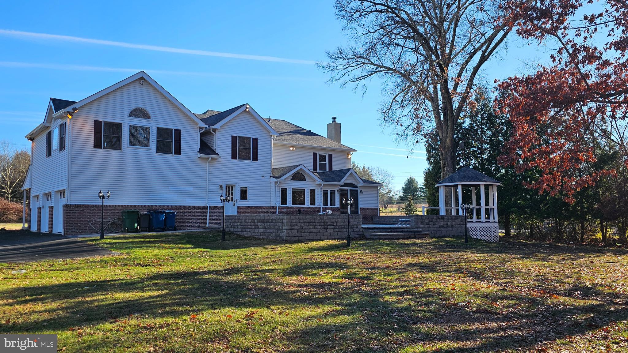 1217 McKean Road Ambler, PA 19002 - Photo 11 of 63 a front view of a house with a yard table and chairs