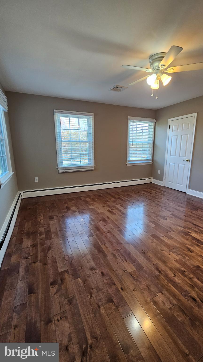 1217 McKean Road Ambler, PA 19002 - Photo 29 of 63 an empty room with wooden floor and windows