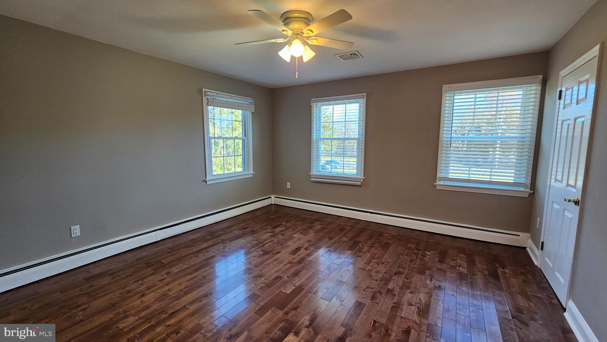1217 McKean Road Ambler, PA 19002 - Photo 30 of 63 a view of an empty room with window and wooden floor