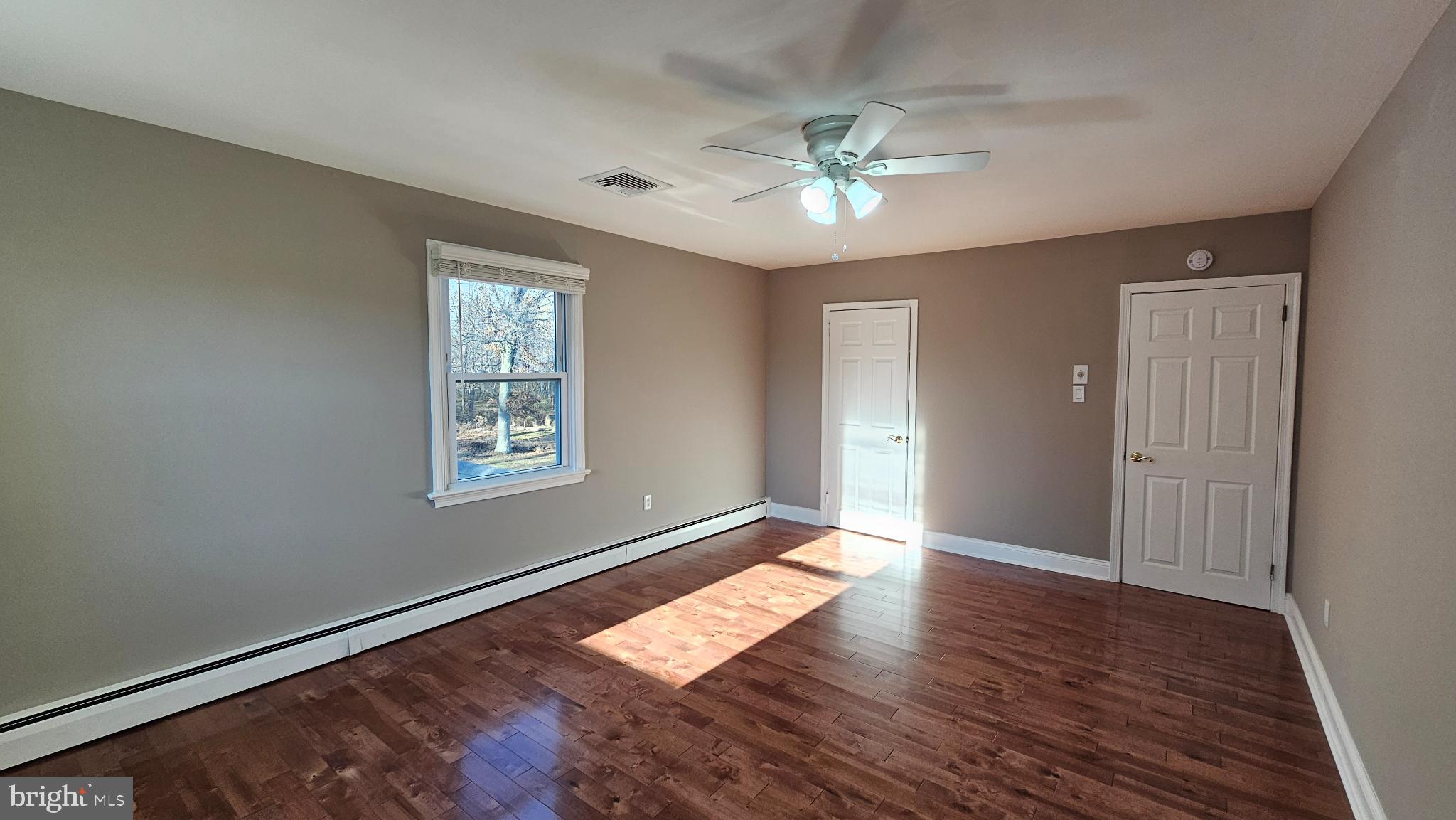 1217 McKean Road Ambler, PA 19002 - Photo 49 of 63 a view of an empty room with wooden floor and a window