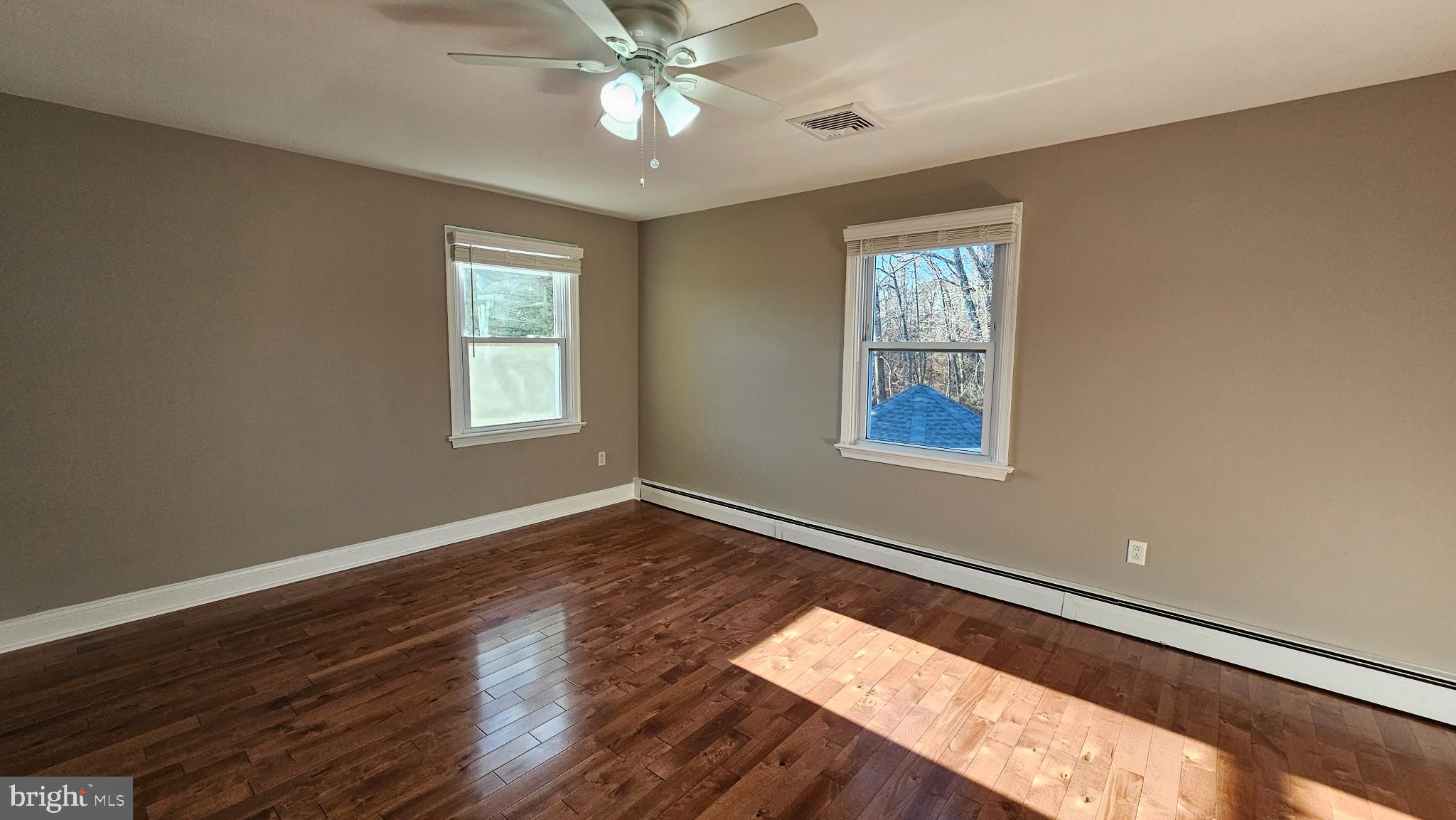 1217 McKean Road Ambler, PA 19002 - Photo 50 of 63 a view of an empty room with wooden floor and a window