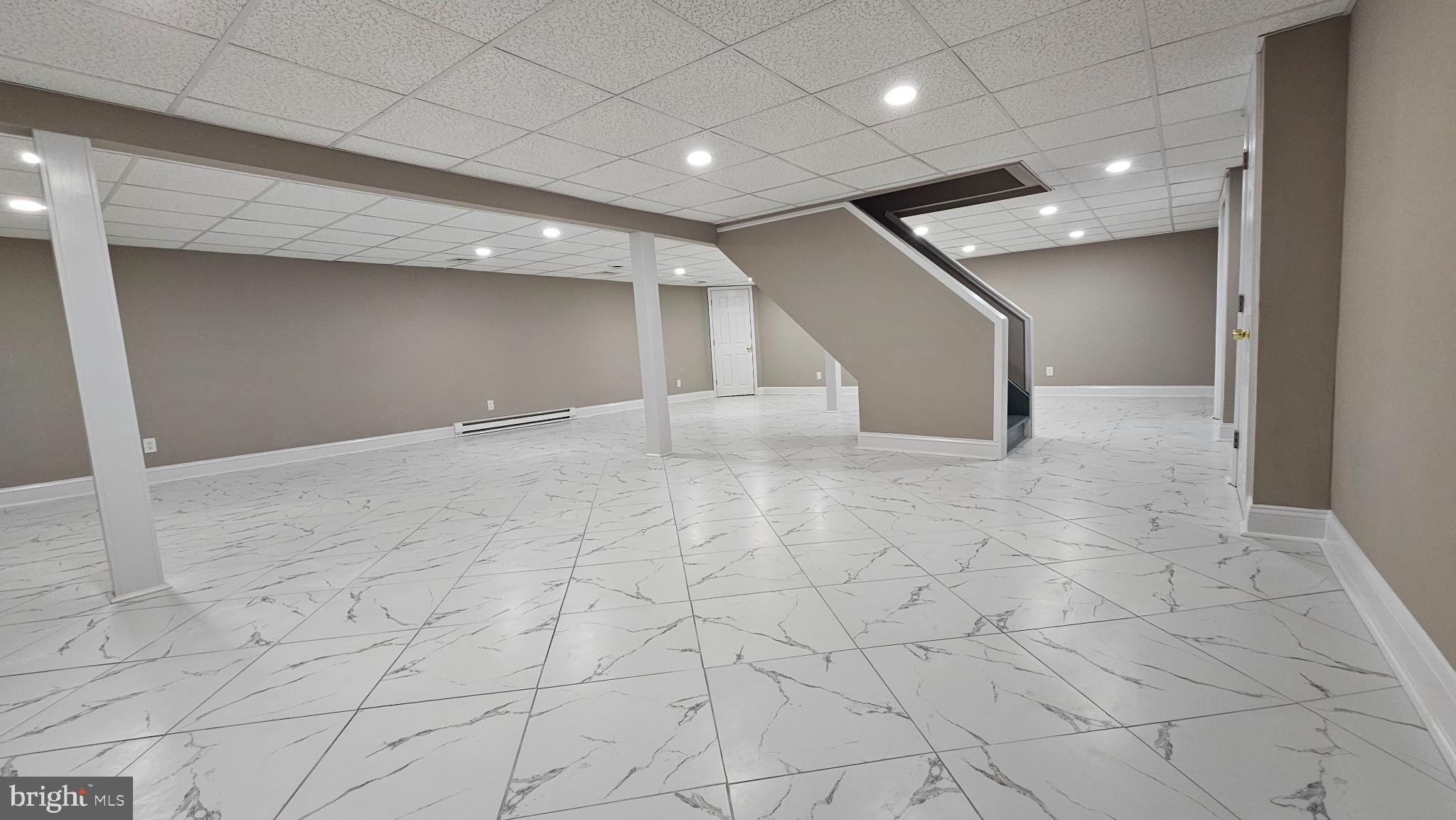 1217 McKean Road Ambler, PA 19002 - Photo 59 of 63 Spacious, modern basement with elegant flooring.