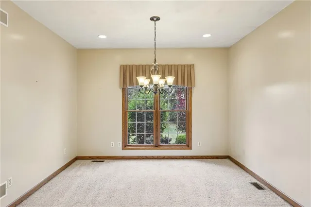 a view of an empty room with windows and outdoor view