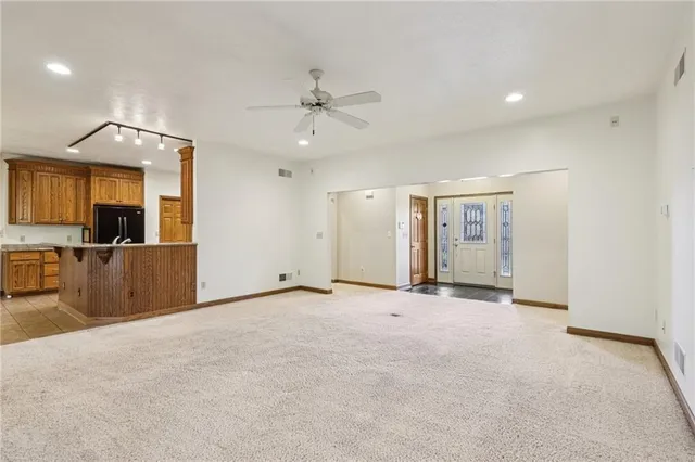 a view of a kitchen with a sink and a refrigerator
