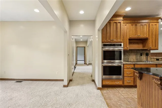 a view of a kitchen with a sink and dishwasher a oven with wooden floor
