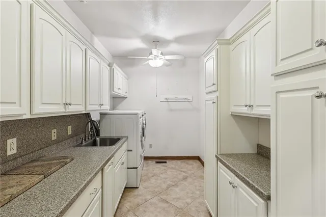 a kitchen with granite countertop a sink a stove and cabinets