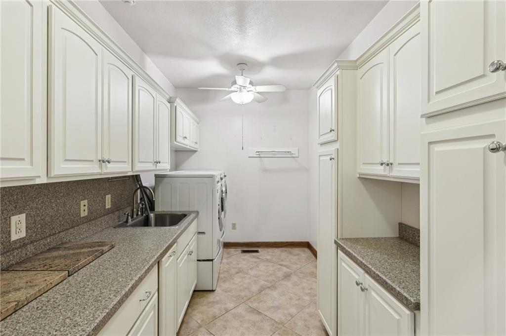 2210 Skyhill Road Edinburg, PA 16116 - Photo 17 of 49 a kitchen with granite countertop a sink a stove and cabinets