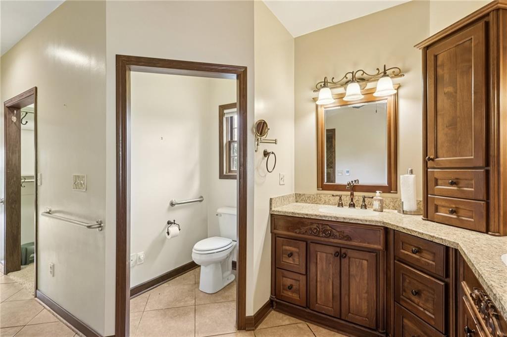 2210 Skyhill Road Edinburg, PA 16116 - Photo 24 of 49 a bathroom with a granite countertop sink toilet and shower