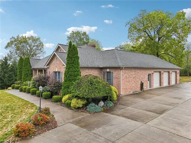 a front view of a house with a yard and a garage