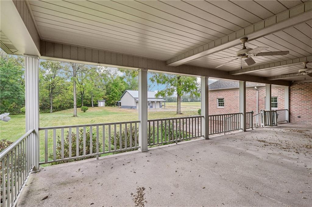 2210 Skyhill Road Edinburg, PA 16116 - Photo 42 of 49 a view of a deck with wooden floor and roof with a floor to ceiling window