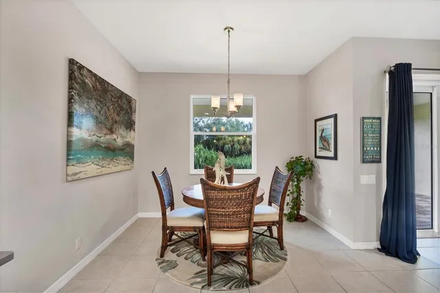 a view of a dining room with furniture and chandelier