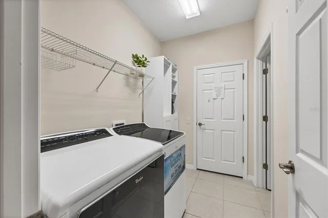 a living room with furniture and a ceiling fan