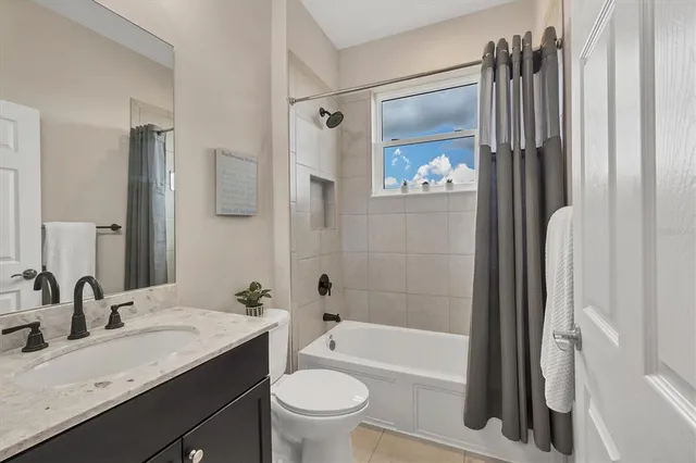 an aerial view of a house with a garden and a yard