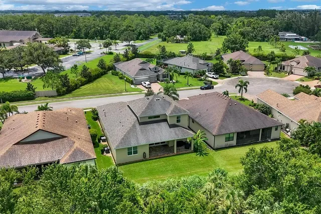 an aerial view of a house with a yard